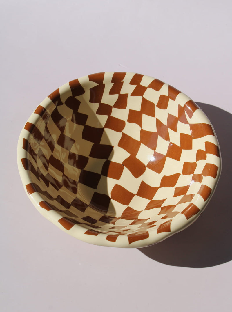 Nova Ceramic Bowl with brown and cream checkered pattern, styled with a green checkered spoon, handmade ceramic bowl top view