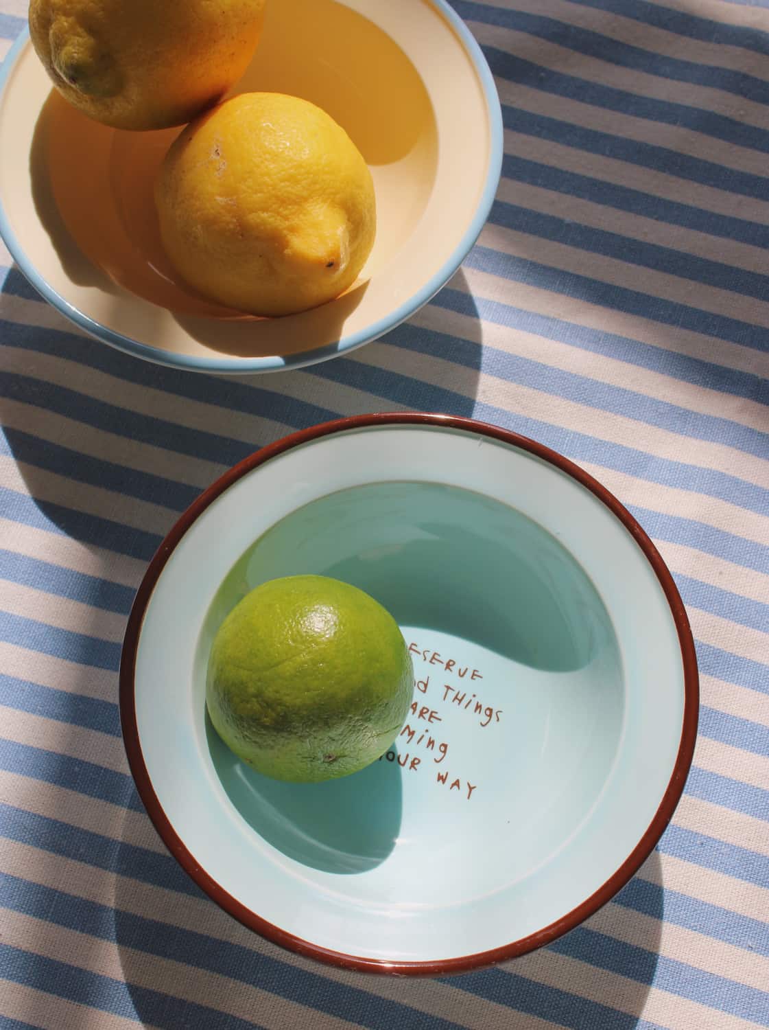 Handmade Cielo ceramic bowl with blue glaze, styled with snacks and fruit for table setting