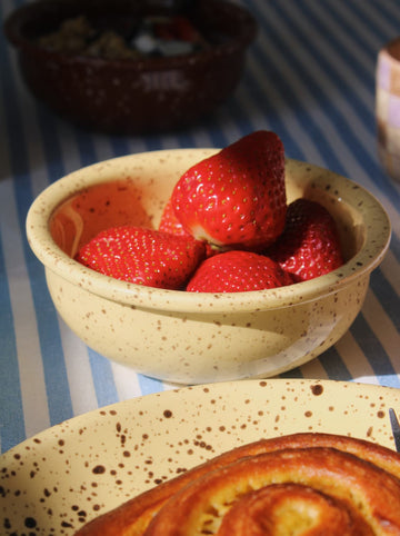 Ocre ceramic bowl with speckled glaze styled with strawberries and yogurt, handmade bowl for breakfast and everyday use.