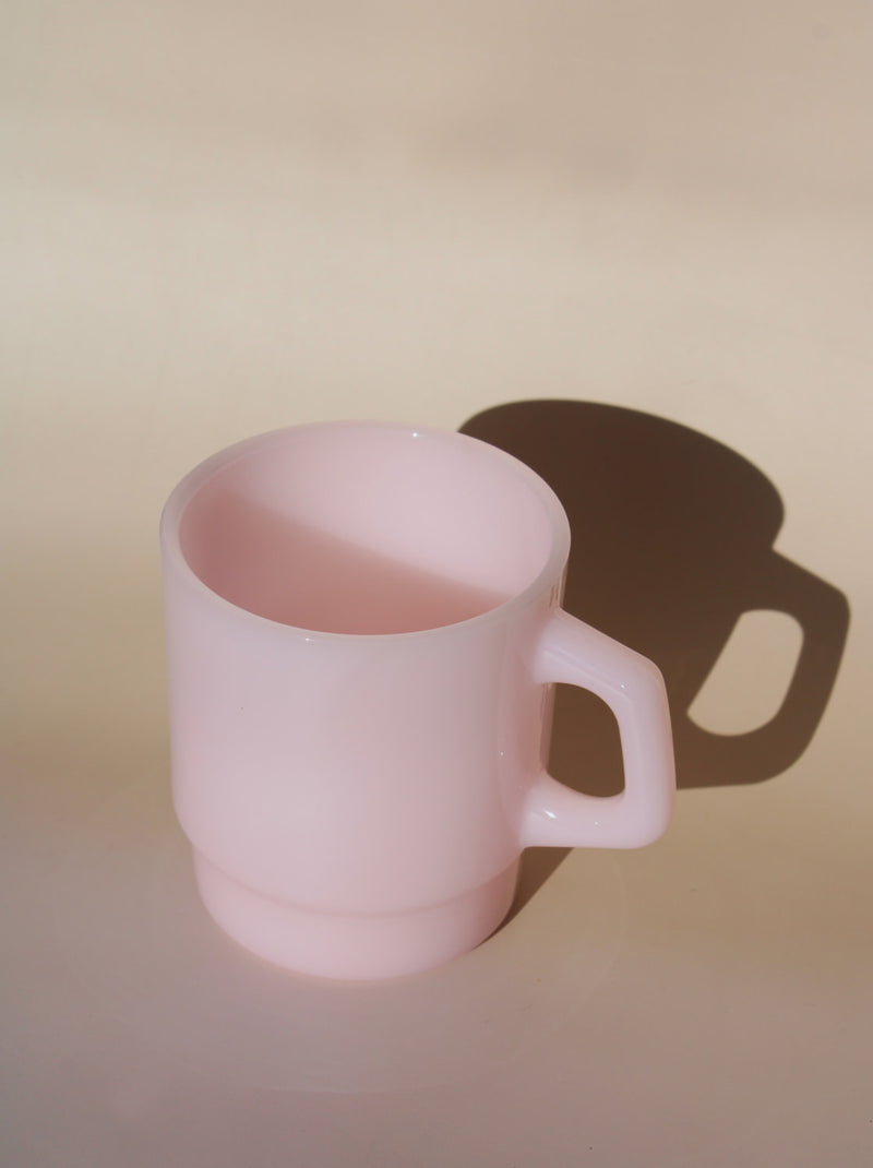 Pink ceramic mug on a beige background