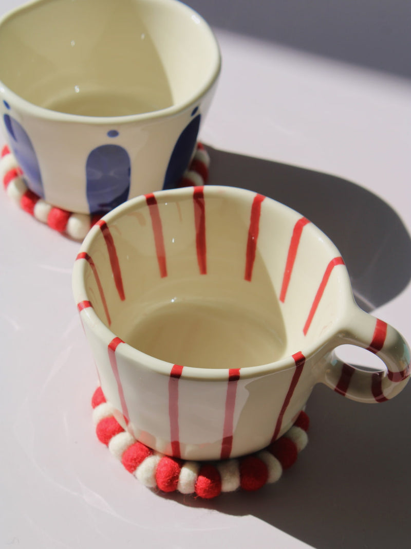 Arlo Ceramic Mug with bold red vertical stripes on a cream base, handmade pottery coffee mug with curved handle