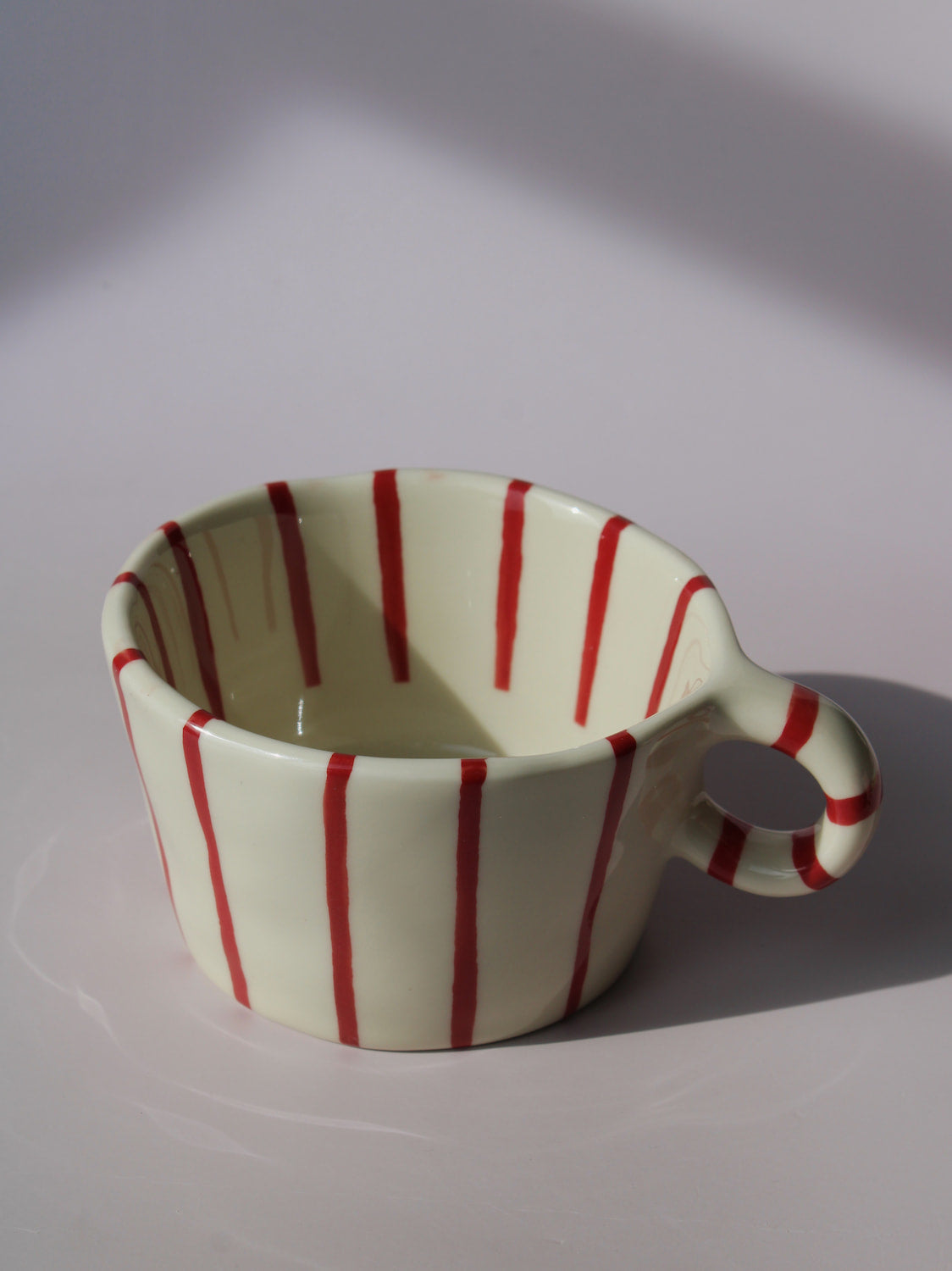 Arlo Ceramic Mug with bold red vertical stripes on a cream base, handmade pottery coffee mug with curved handle
