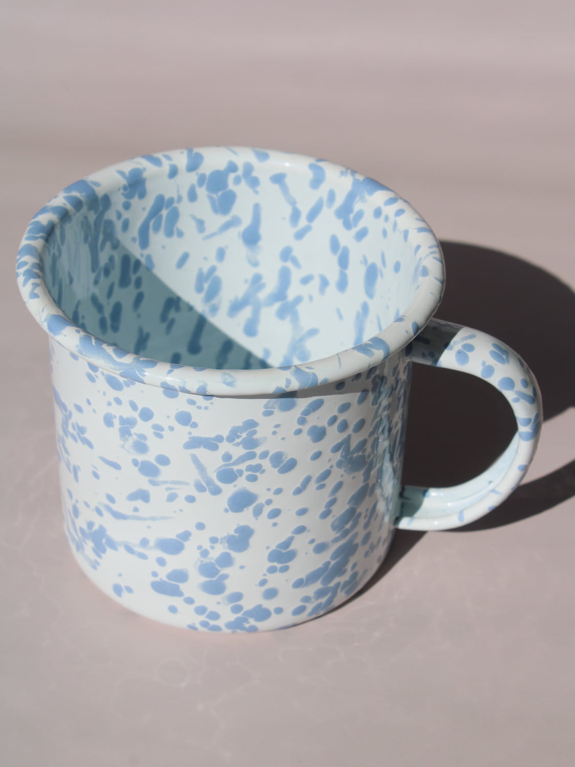 Aeris Enamel Mug in speckled baby blue, handmade enamel coffee mug top angle view