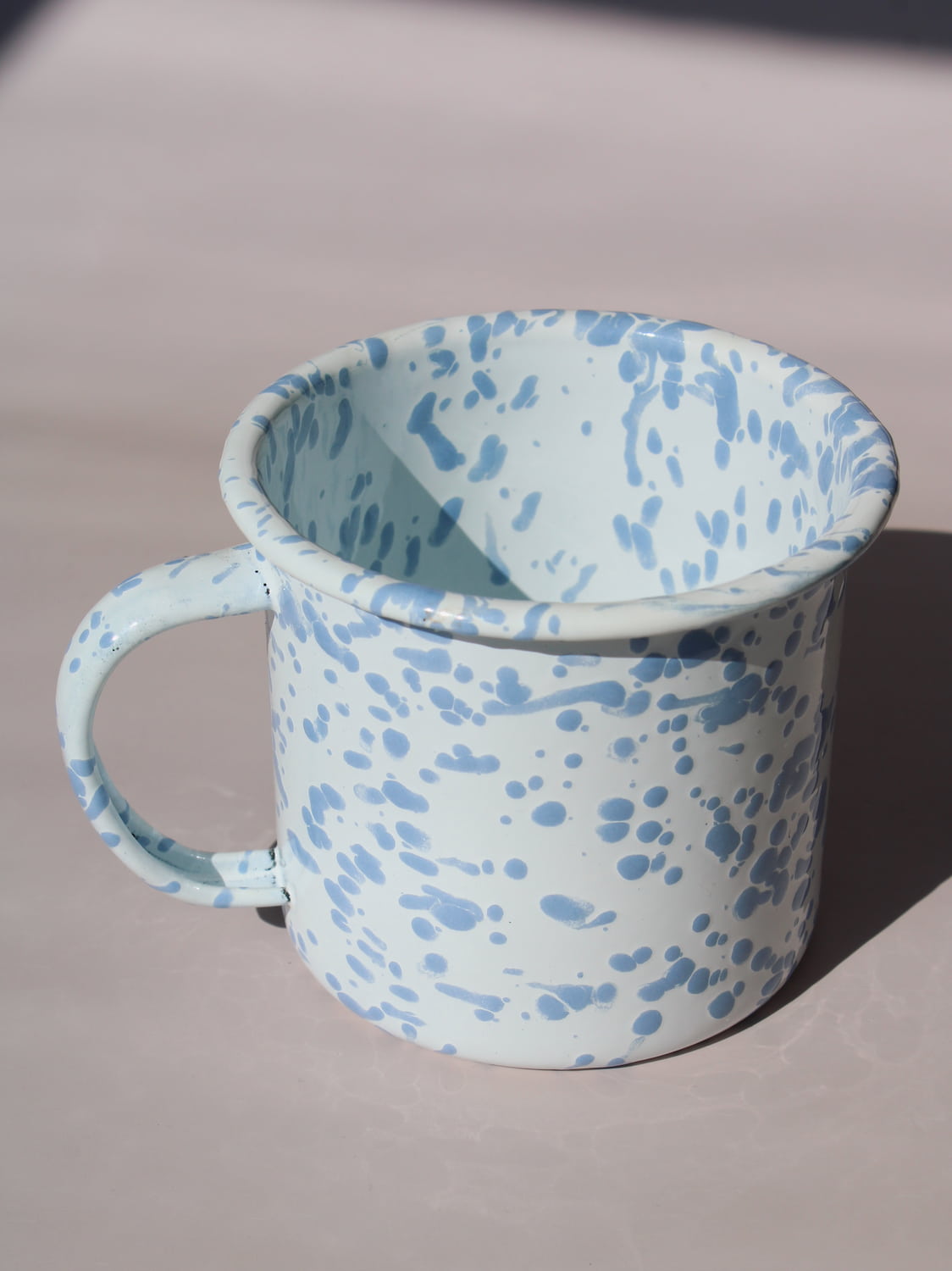 Aeris Enamel Mug in speckled baby blue, handmade enamel coffee mug top angle view