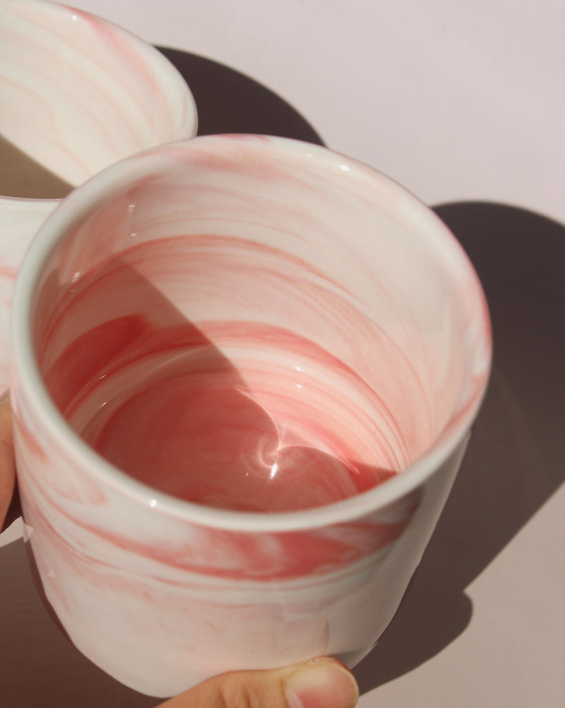 Blush ceramic cup with soft pink marble swirl glaze, handmade stoneware cup for coffee, tea, or everyday drinks.