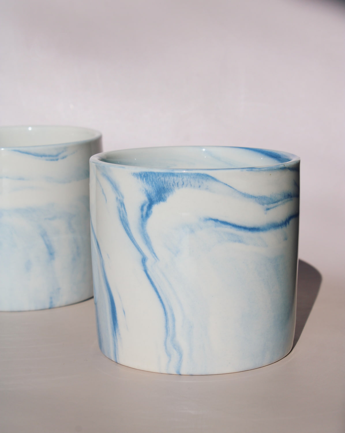 Two Sumi ceramic cups with blue marble swirl glaze, handmade stoneware cups for coffee or tea.