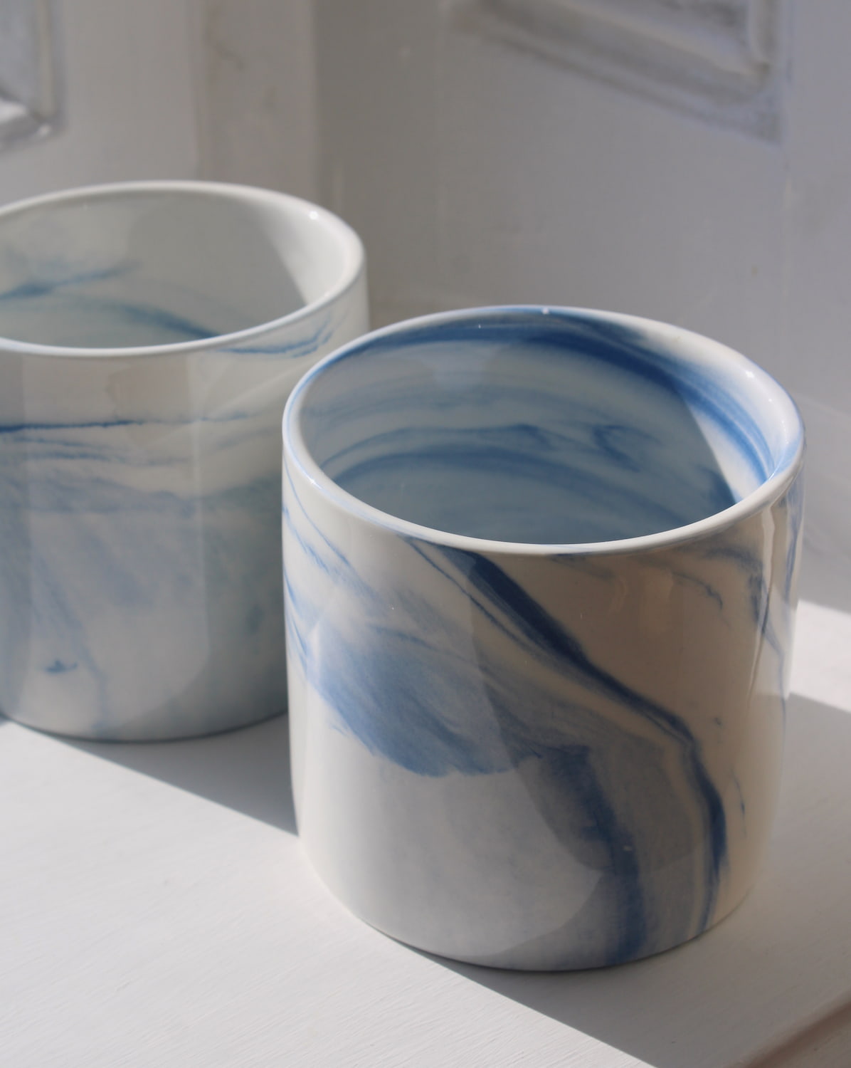 Two Sumi ceramic cups with blue marble swirl glaze, handmade stoneware cups for coffee or tea.