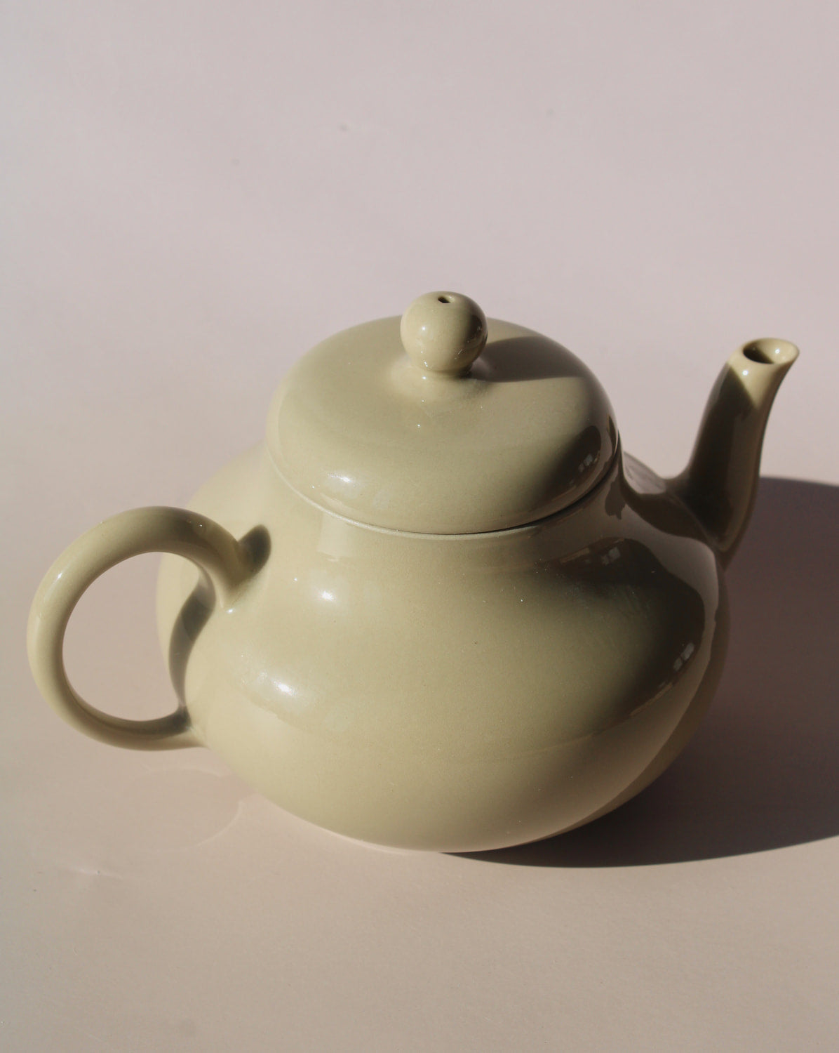 Sumi ceramic teapot in soft sage glaze with rounded shape and lid, minimalist handmade teapot for loose leaf tea.