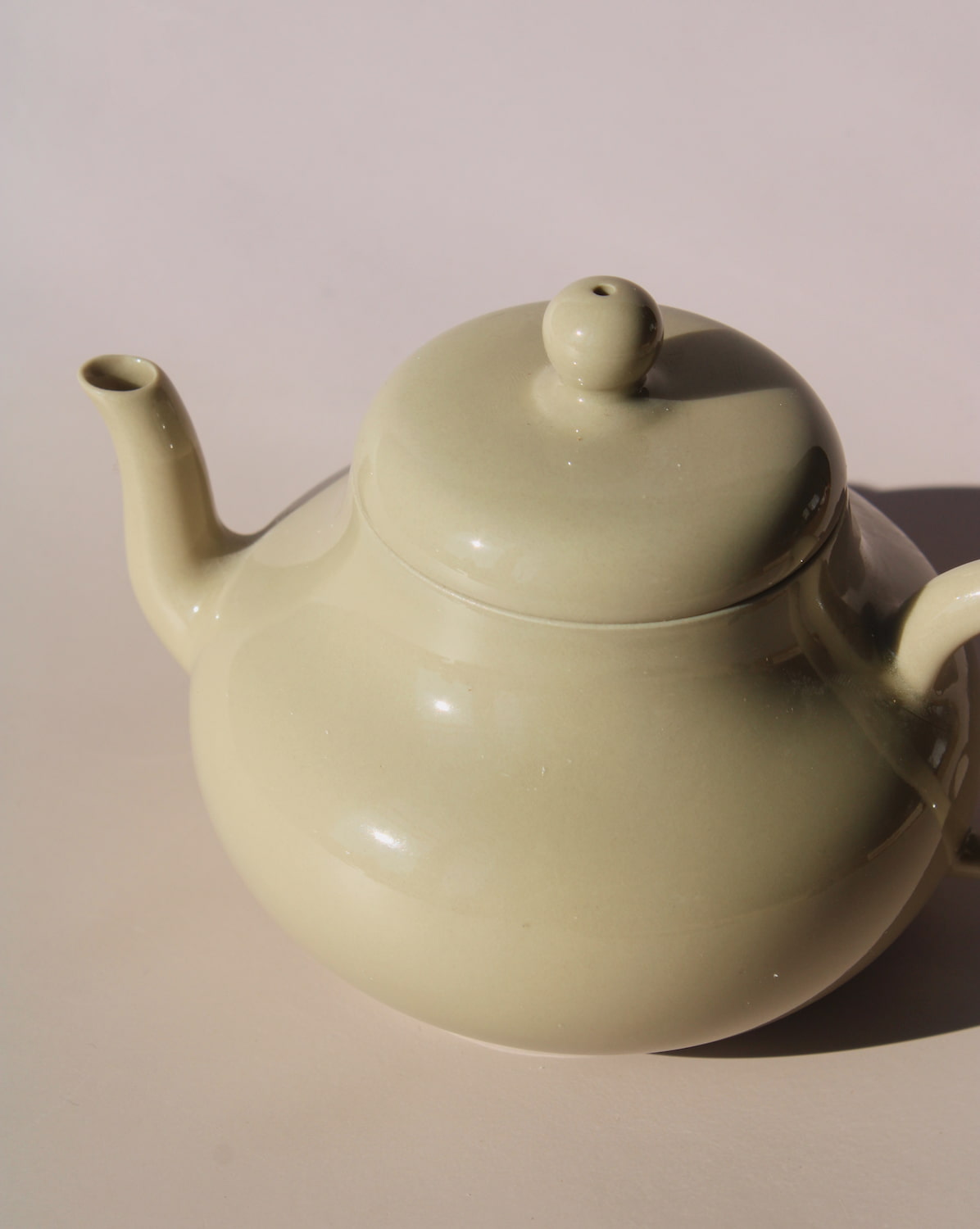 Sumi ceramic teapot in soft sage glaze with rounded shape and lid, minimalist handmade teapot for loose leaf tea.