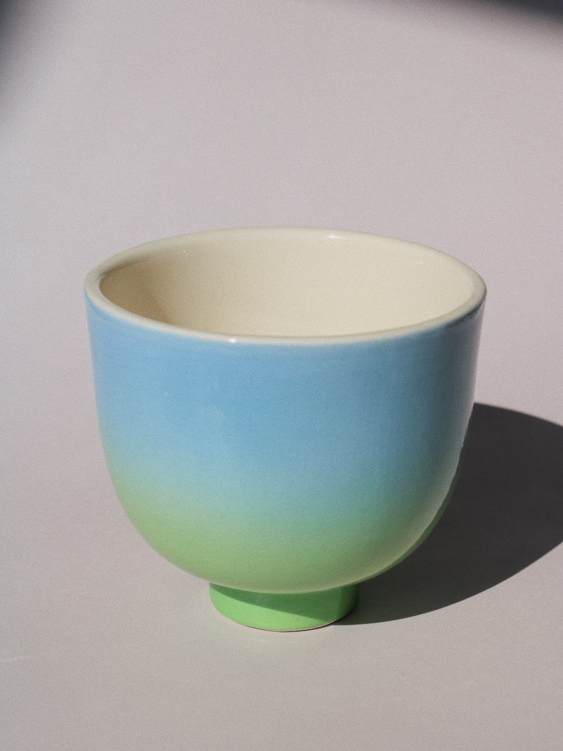 Sky Yunomi Cup against a pink background