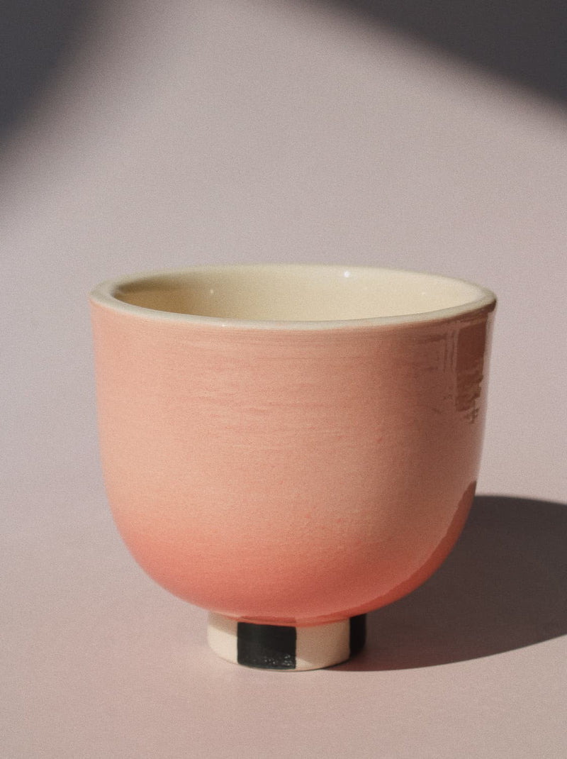 Sunset Yunomi Cup against a pink background