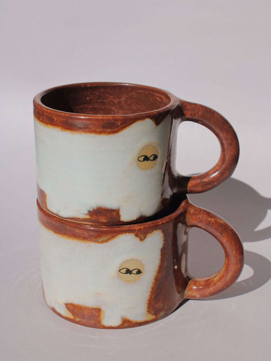 Chestnut Ceramic Cat Mug by Marta Shurpakova – handmade brown and cream ceramic mug with a playful cat design