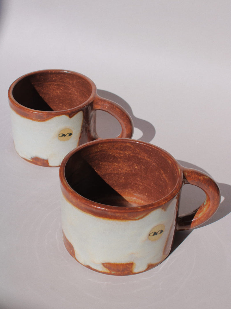Chestnut Ceramic Cat Mug by Marta Shurpakova – handmade brown and cream ceramic mug with a playful cat design