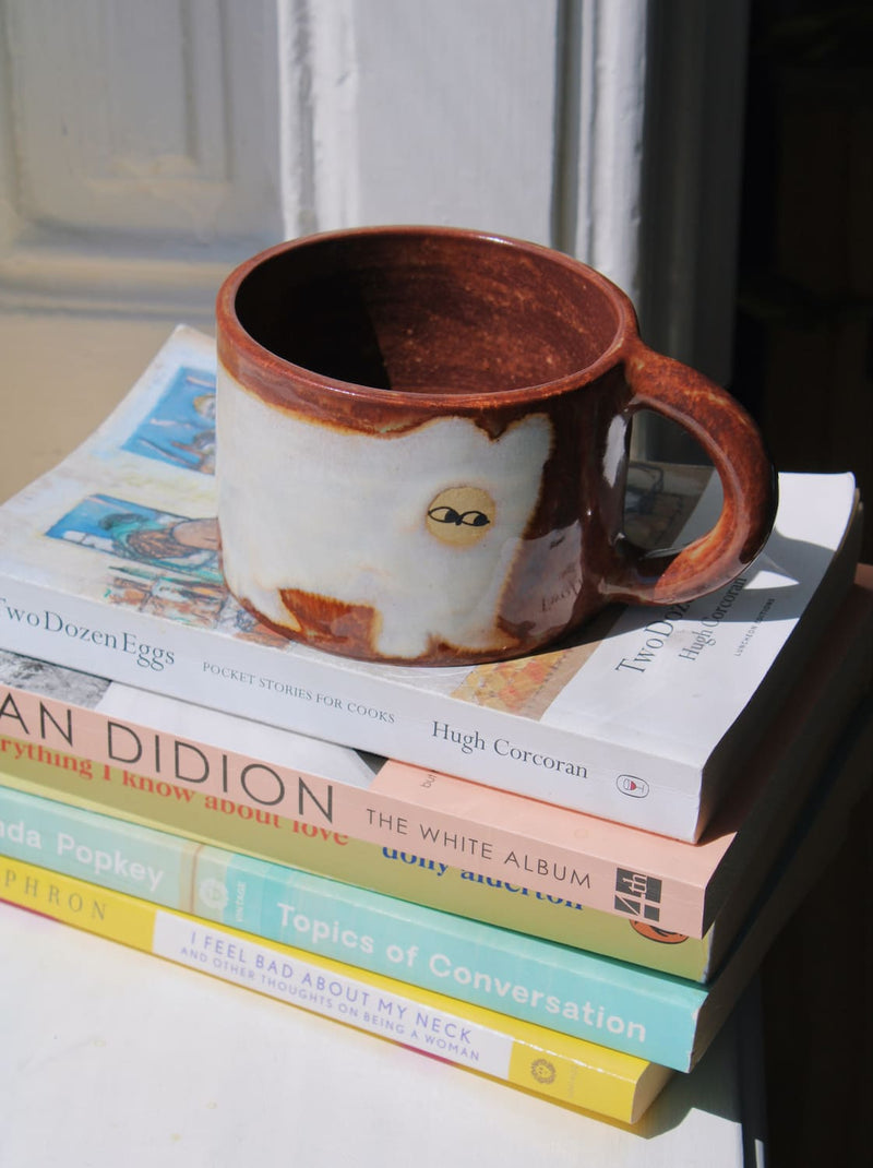 Chestnut Ceramic Cat Mug by Marta Shurpakova – handmade brown and cream ceramic mug with a playful cat design
