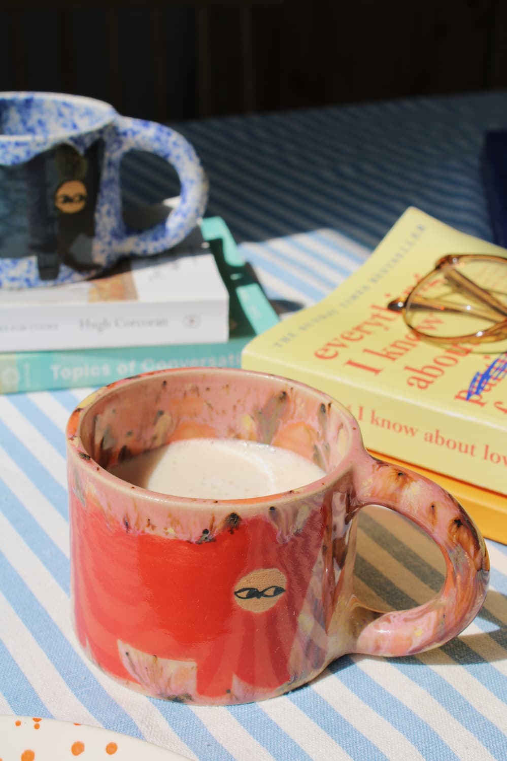 Poppy Ceramic Cat Mug by Marta Shurpakova – handmade ceramic mug with a playful cat design in a colourful home setting