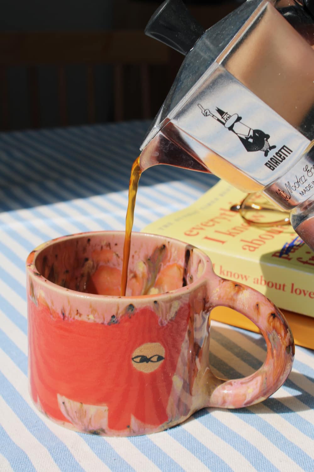 Poppy Ceramic Cat Mug by Marta Shurpakova – handmade ceramic mug with a playful cat design in a colourful home setting