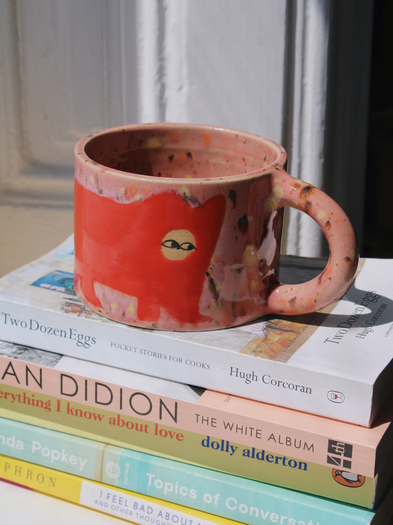 Poppy Ceramic Cat Mug by Marta Shurpakova – handmade ceramic mug with a playful cat design in a colourful home setting