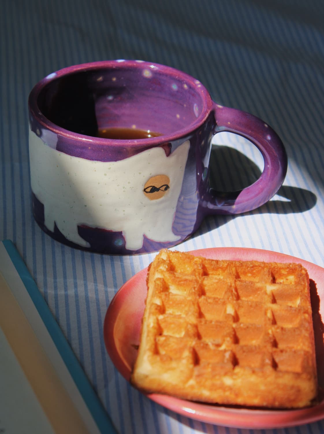Mulberry Ceramic Cat Mug by Marta Shurpakova – handmade ceramic mug with a playful cat design styled with a sweet treat
