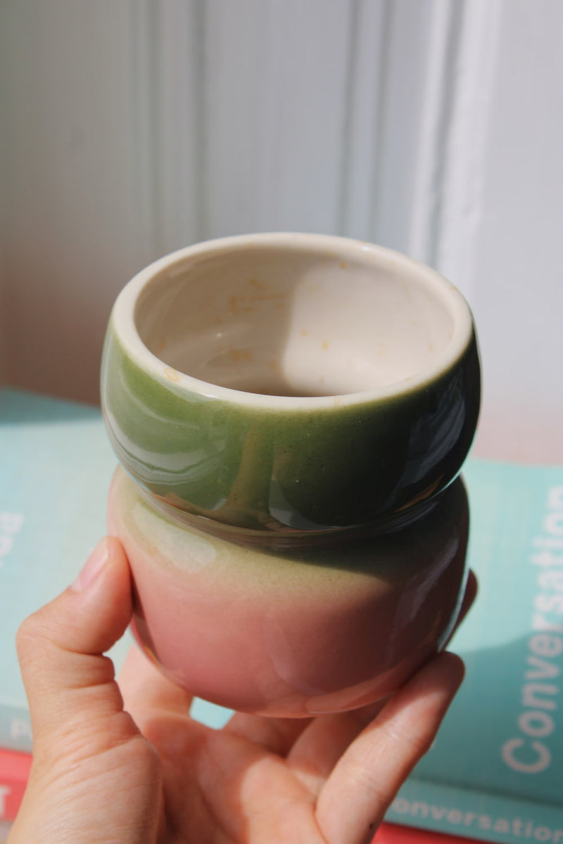 Belly Garden Ceramic Mug by Agata Puławska – colourful handmade ceramic mug styled with coffee 