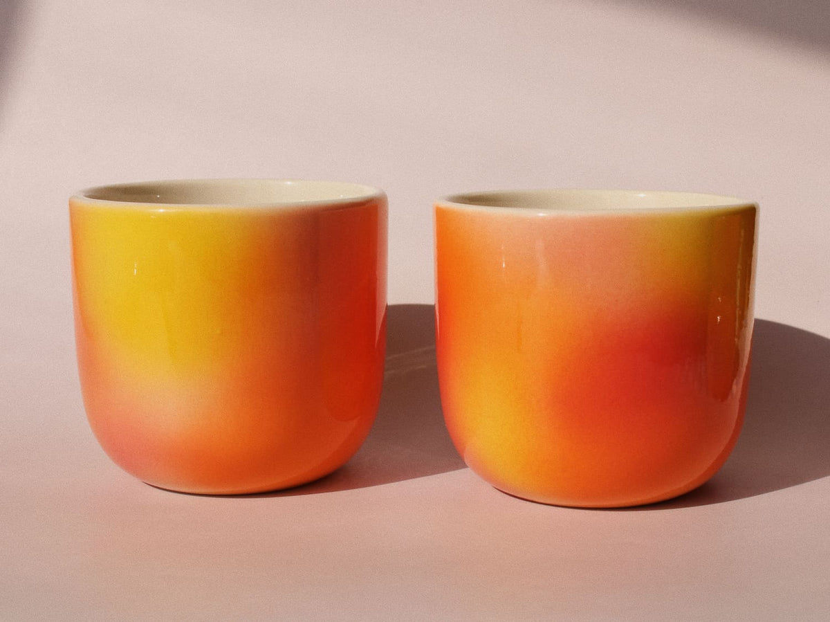 Sunset Gradient Ceramic Cup by Agata Puławska – handmade ceramic cup with a warm yellow, orange and coral gradient