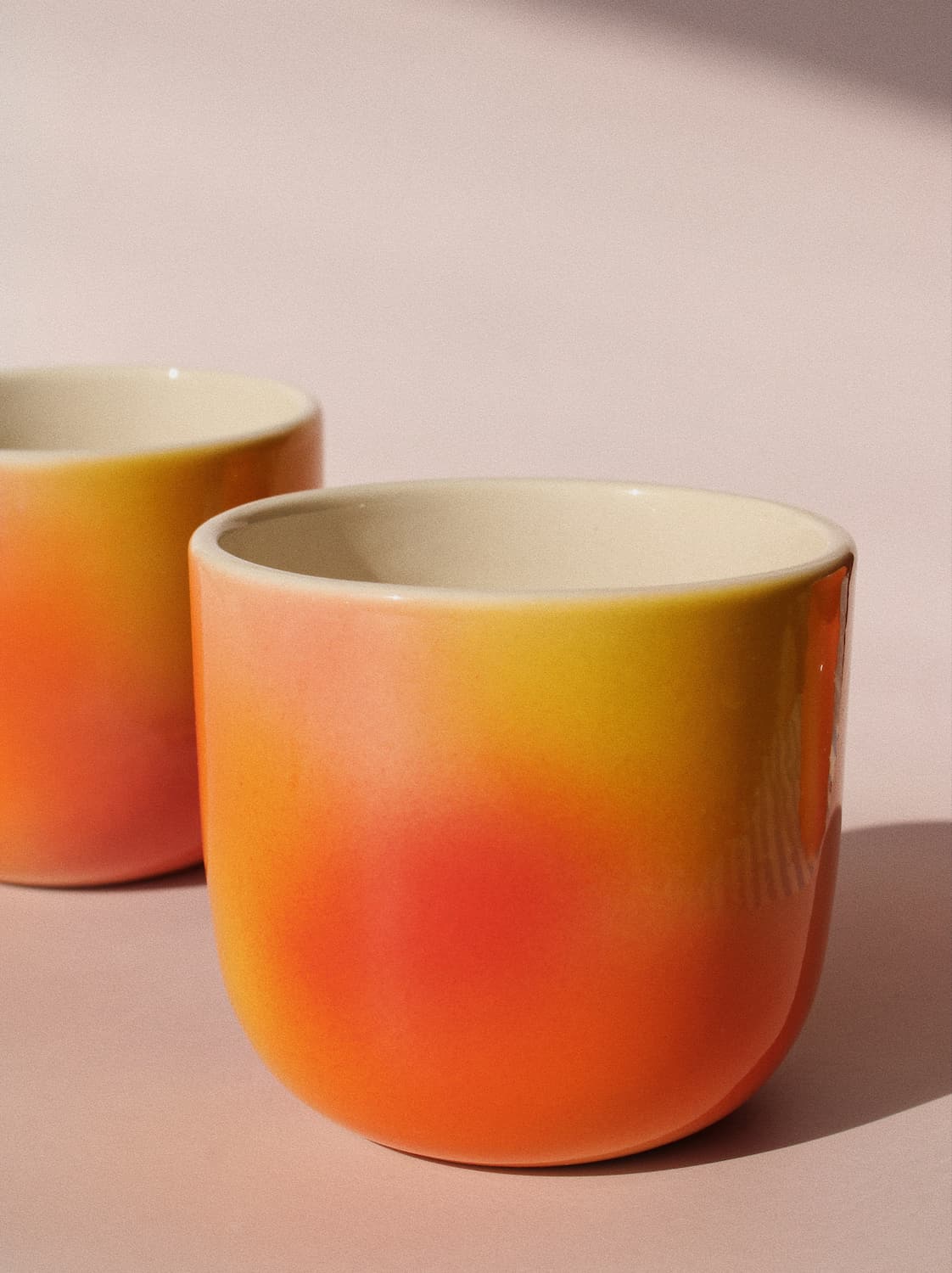 Sunset Gradient Ceramic Cup by Agata Puławska – handmade ceramic cup with a warm yellow, orange and coral gradient