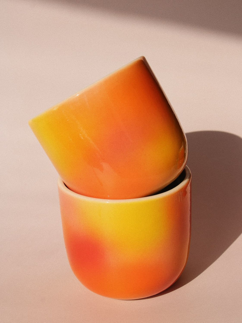 Sunset Gradient Ceramic Cup by Agata Puławska – handmade ceramic cup with a warm yellow, orange and coral gradient