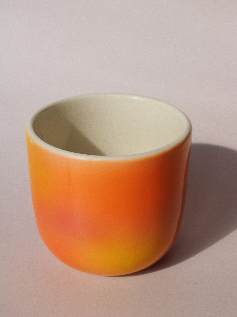 Sunset Gradient Ceramic Cup by Agata Puławska – handmade ceramic cup with a warm yellow, orange and coral gradient