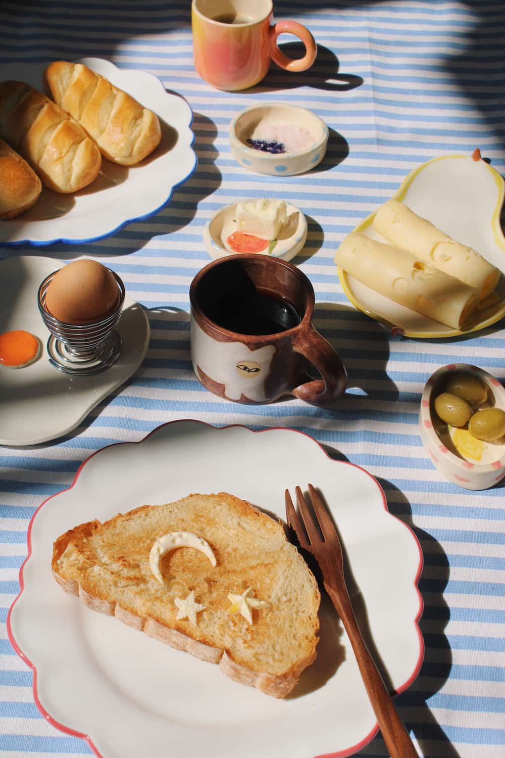 Pia ceramic plate with scalloped edge styled with toast and breakfast table setting