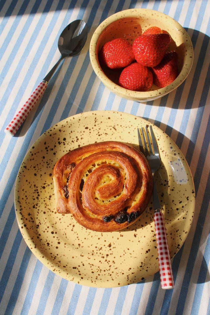 Handmade Ocre ceramic plate with speckled finish styled with breakfast, matched with Ocre ceramic bowl.
