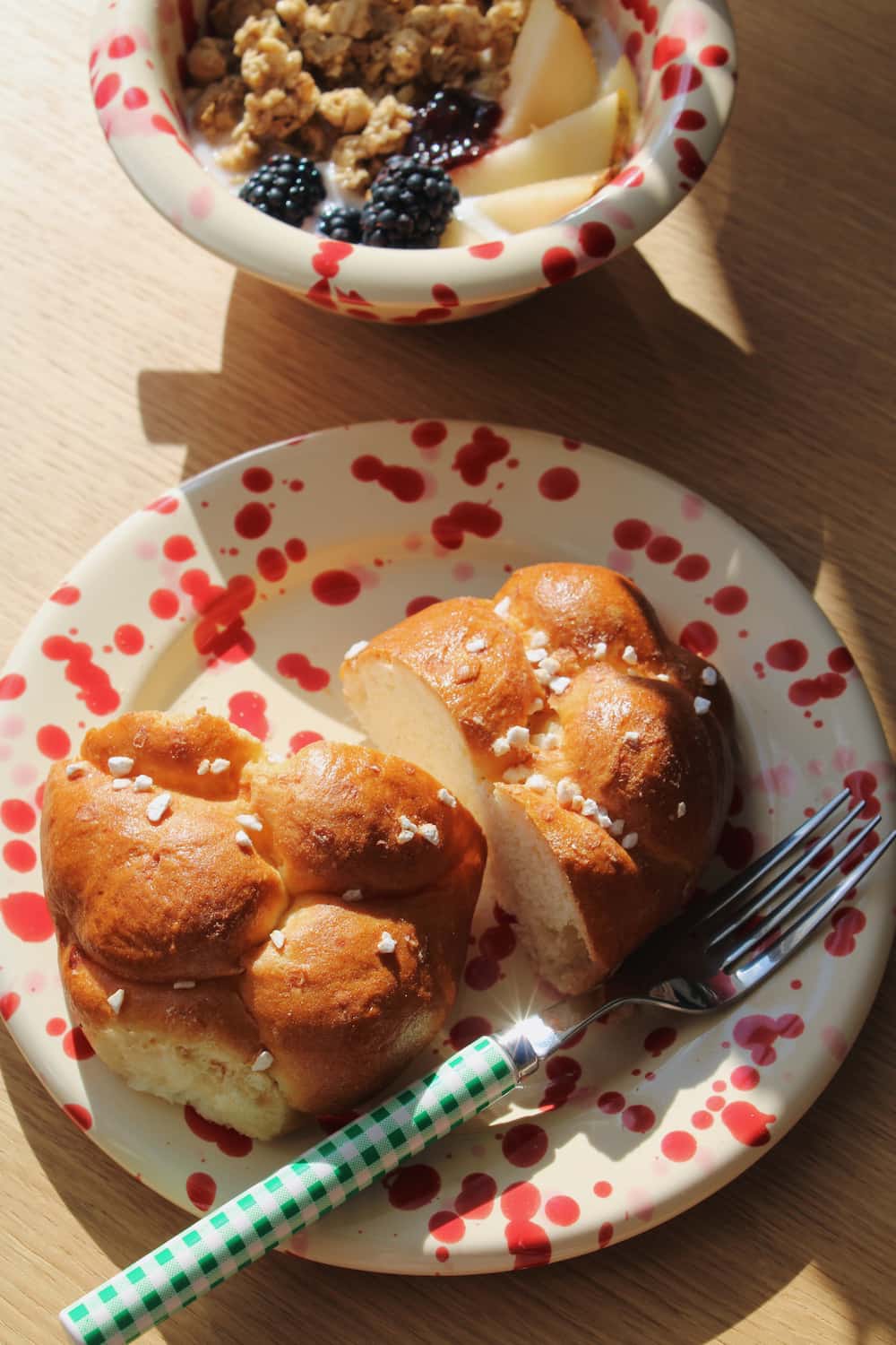 Dotty Ceramic Plate in cream with red speckled dot pattern, styled with a brioche 