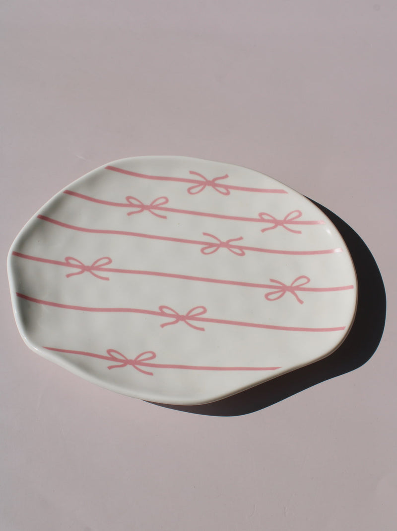 Lina Ceramic Plate with pink bow and ribbon line pattern, organic-shaped handmade ceramic plate top view