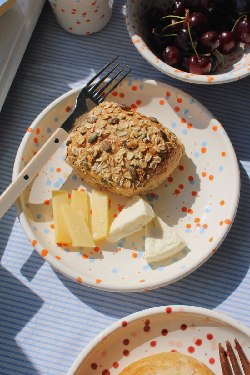 Naro Ceramic Plate styled with a seeded bread roll and cheese