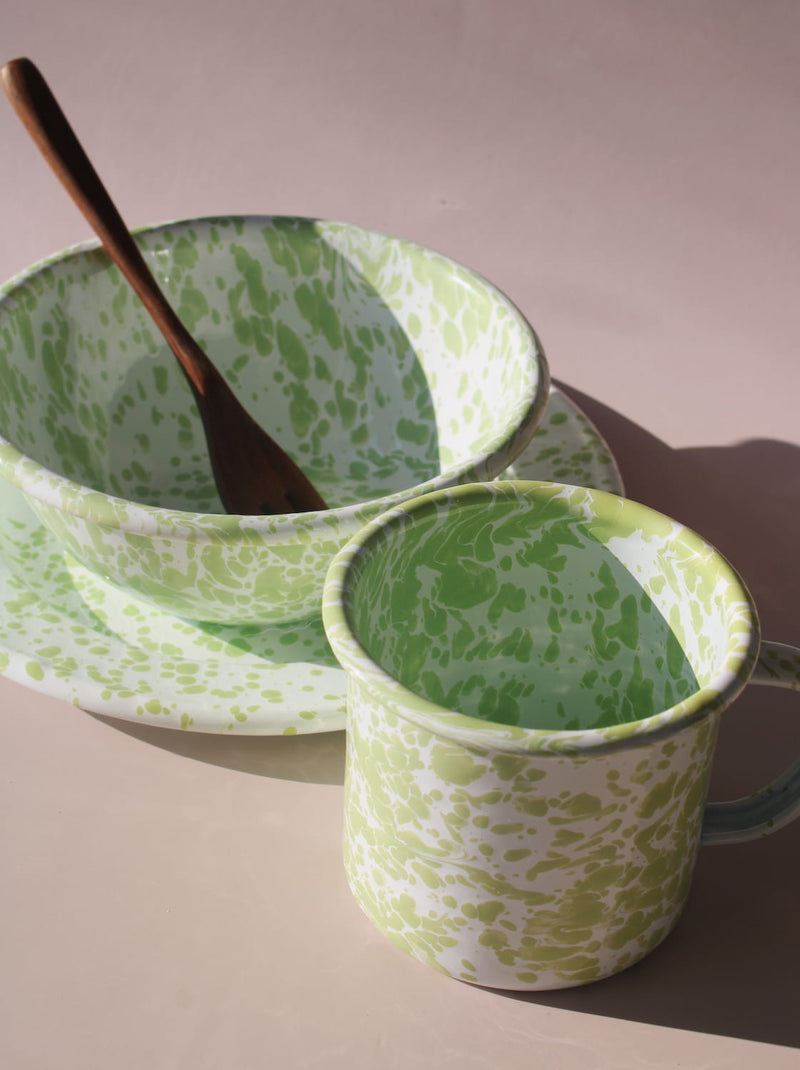 Green and white patterned bowl and mug set on a beige background