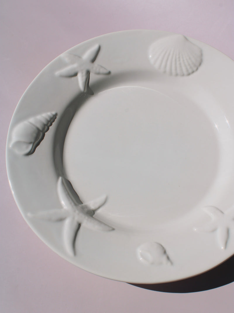 Caspia Ceramic Plate with embossed starfish, seashells and conch border, white ceramic dinner plate top view