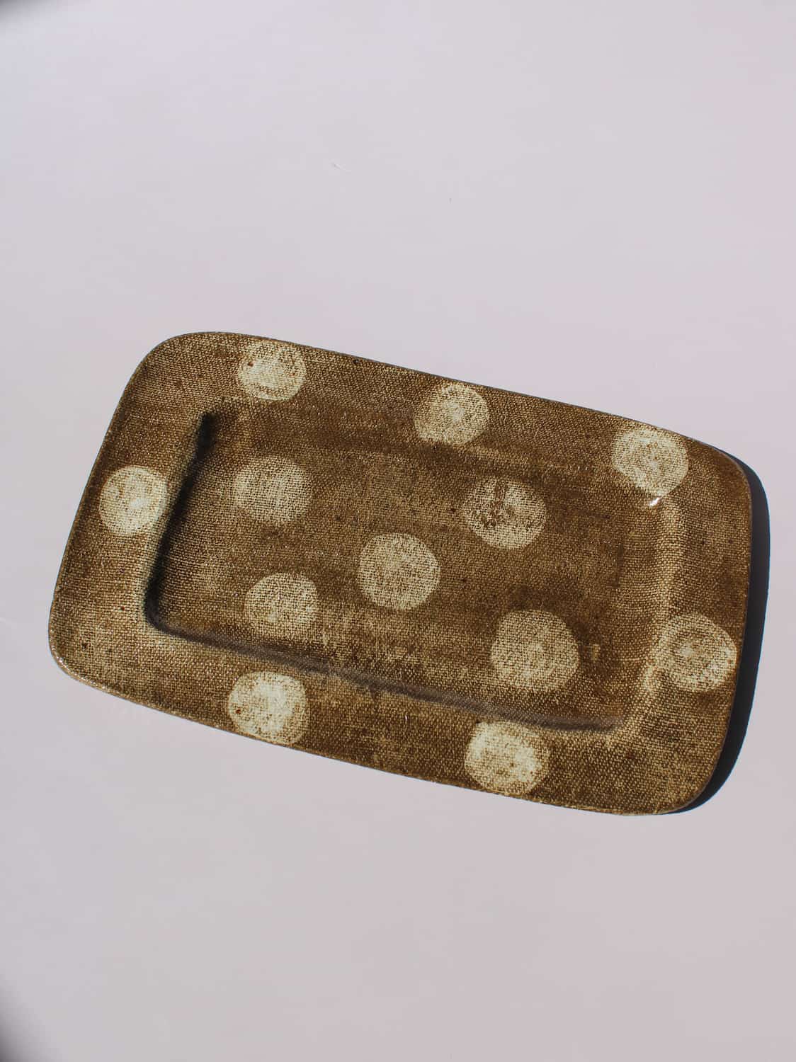 Biscotti Ceramic Plate in brown with ivory polka dots, rectangular handmade ceramic serving plate top view