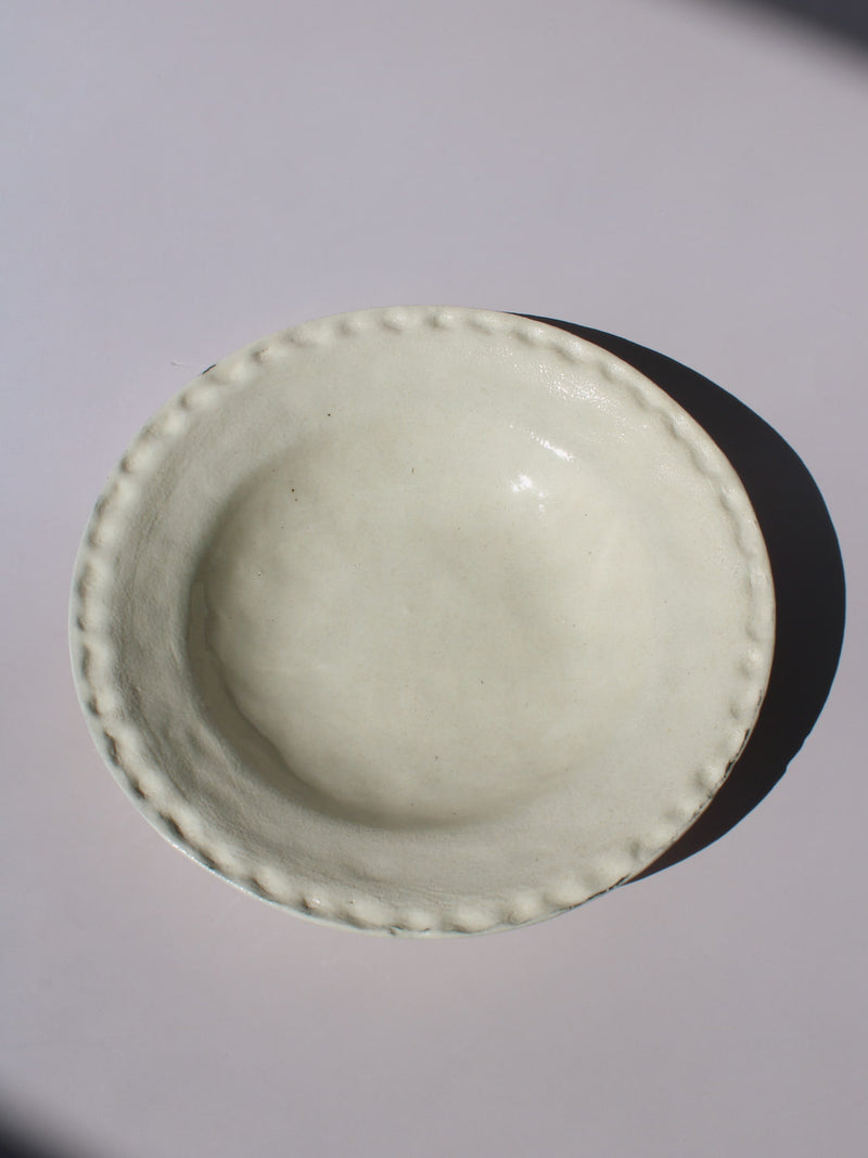 Lunette Ceramic Plate with scalloped beaded edge, styled with a wooden fork, handmade ceramic plate top view