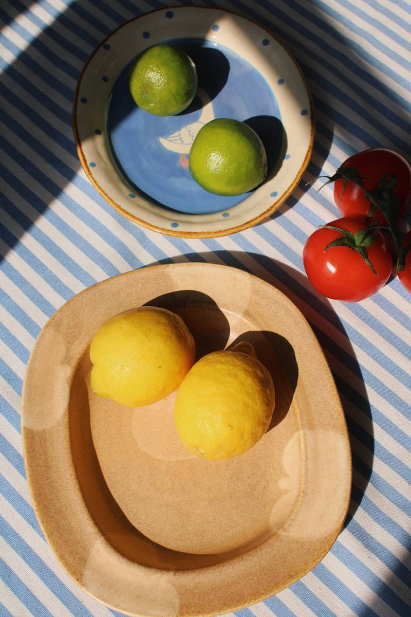 Fruit-themed Pom ceramic plate with lemons, paired with blue Pond plate, handmade plates for everyday use