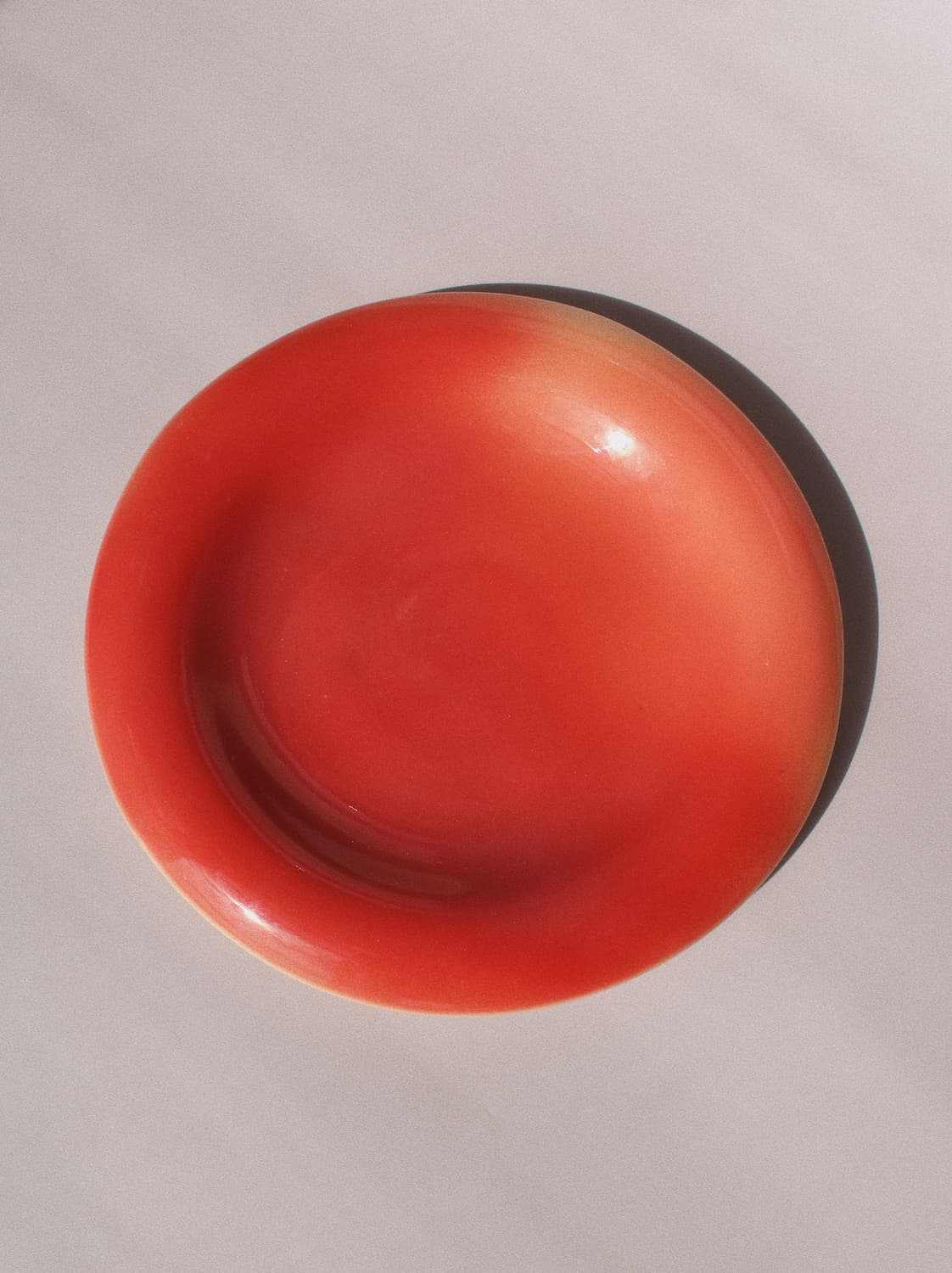 Belly Poppy Ceramic Plate by Agata Puławska – handmade ceramic plate in a rich poppy red glaze with a glossy finish