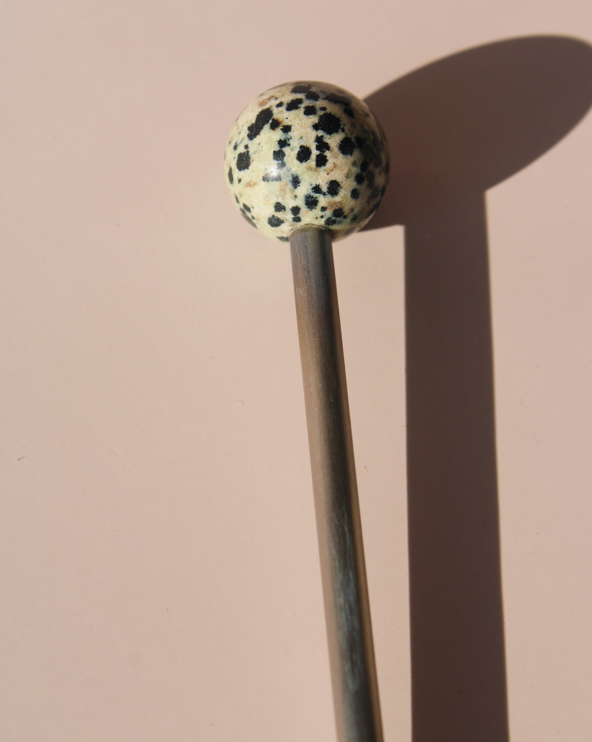 Nebula Astra Stone Stirrer with black and white speckled stone top, sculptural drink stirrer for cocktails, coffee, or matcha.