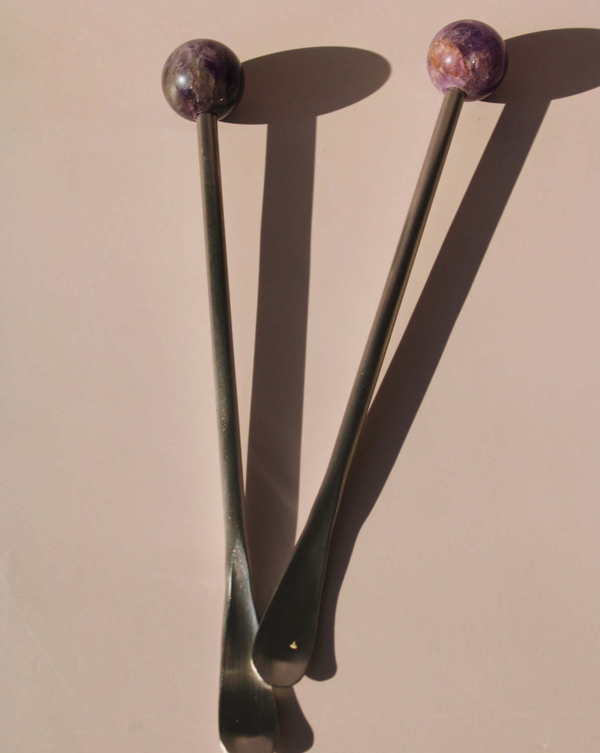 Astra Stone Stirrer collection featuring Nebula, Aster, Amethyst, and Ember stone drink stirrers in sculptural barware design.