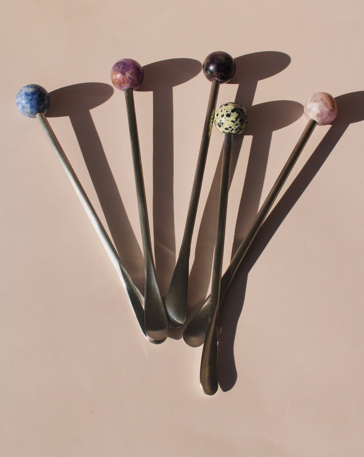 Astra Stone Stirrer collection featuring Nebula, Aster, Amethyst, and Ember stone drink stirrers in sculptural barware design.