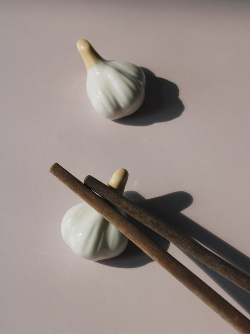Garlic Ceramic Chopstick Rest Set shaped like garlic cloves with golden brown stems, handmade ceramic