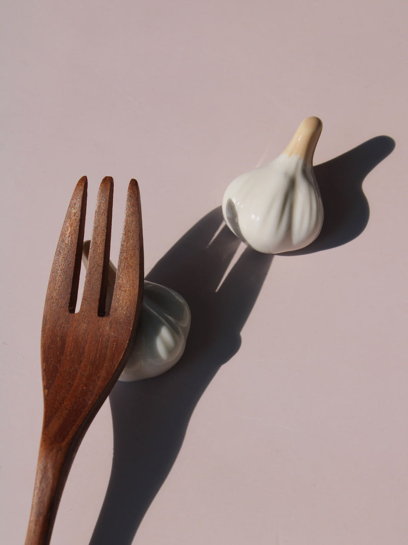 Garlic Ceramic Chopstick Rest Set shaped like garlic cloves with golden brown stems, handmade ceramic