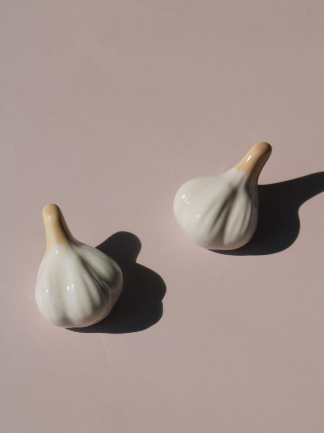 Garlic Ceramic Chopstick Rest Set shaped like garlic cloves with golden brown stems, handmade ceramic