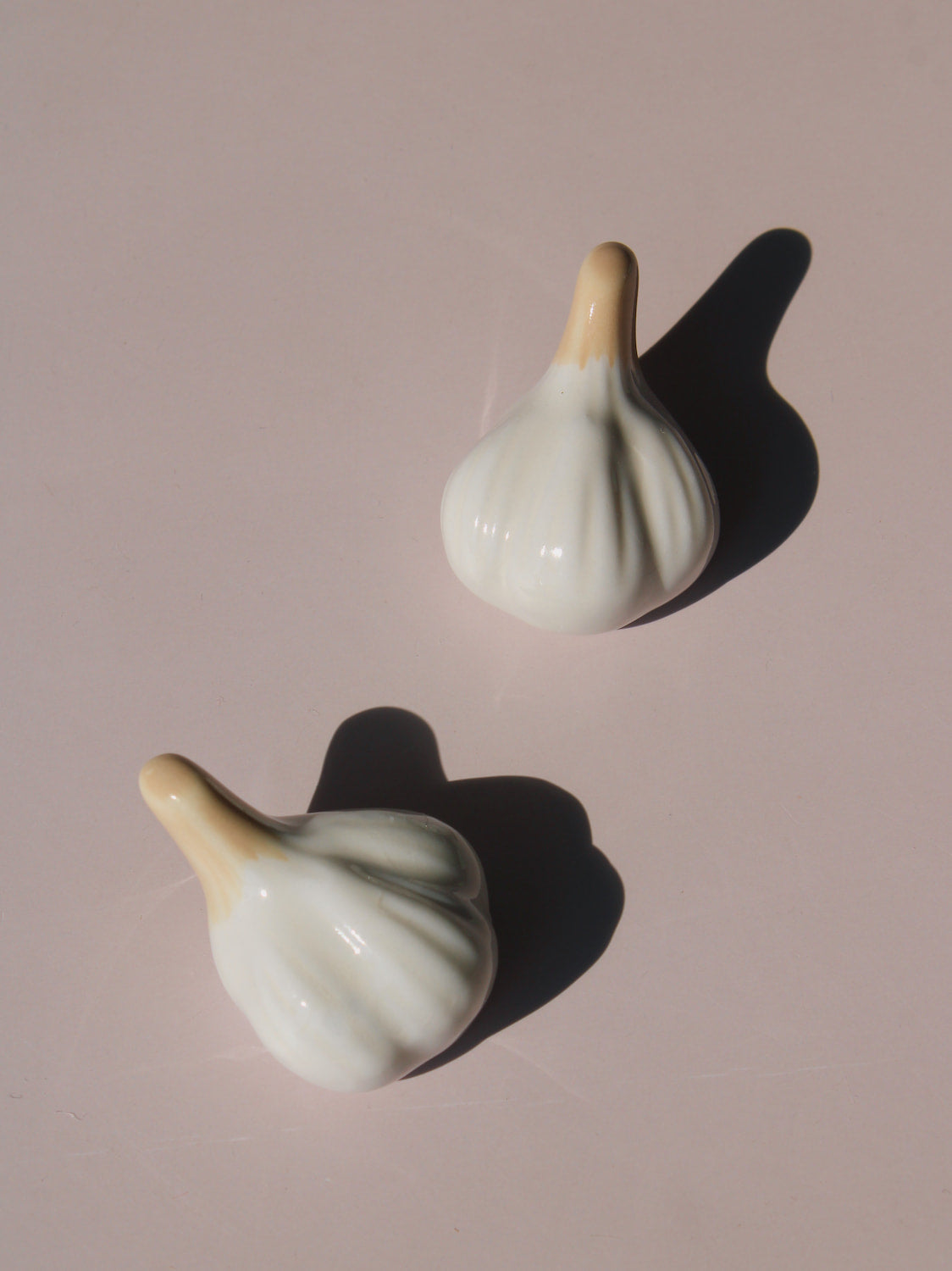 Garlic Ceramic Chopstick Rest Set shaped like garlic cloves with golden brown stems, handmade ceramic