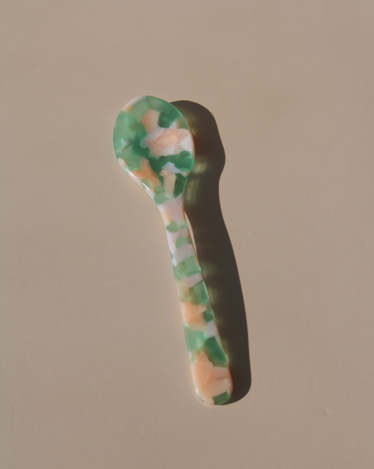 Green and peach marbled acrylic spoons, handmade-look resin dessert spoons for stylish table settings.