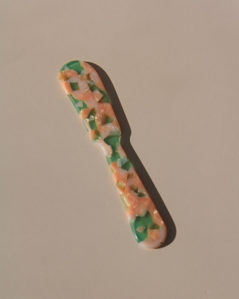 Green and peach marbled acrylic spoons, handmade-look resin dessert spoons for stylish table settings.