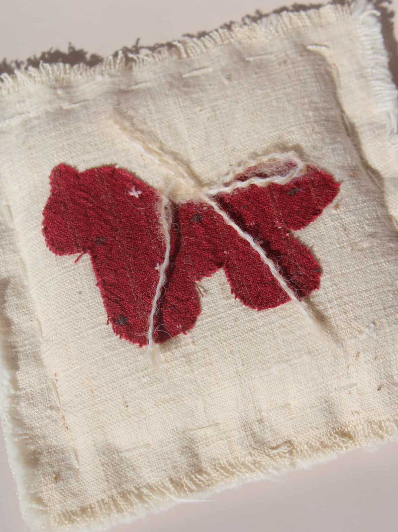 Écurie handmade horse coaster with red embroidered horse design on natural cotton fabric, hand-sewn textile coaster.
