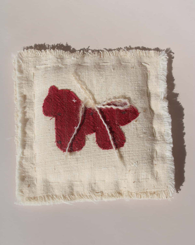 Écurie handmade horse coaster with red embroidered horse design on natural cotton fabric, hand-sewn textile coaster.