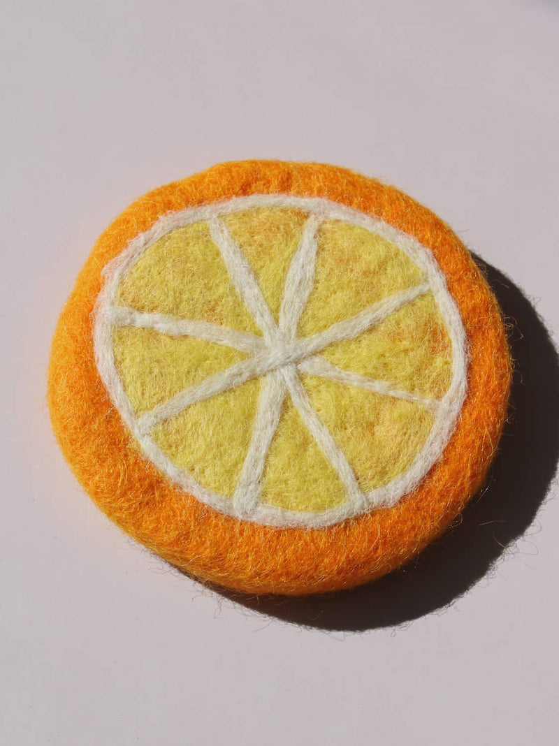 Clementine Handmade Coaster shaped like an orange citrus slice, felted wool coaster with white pith lines